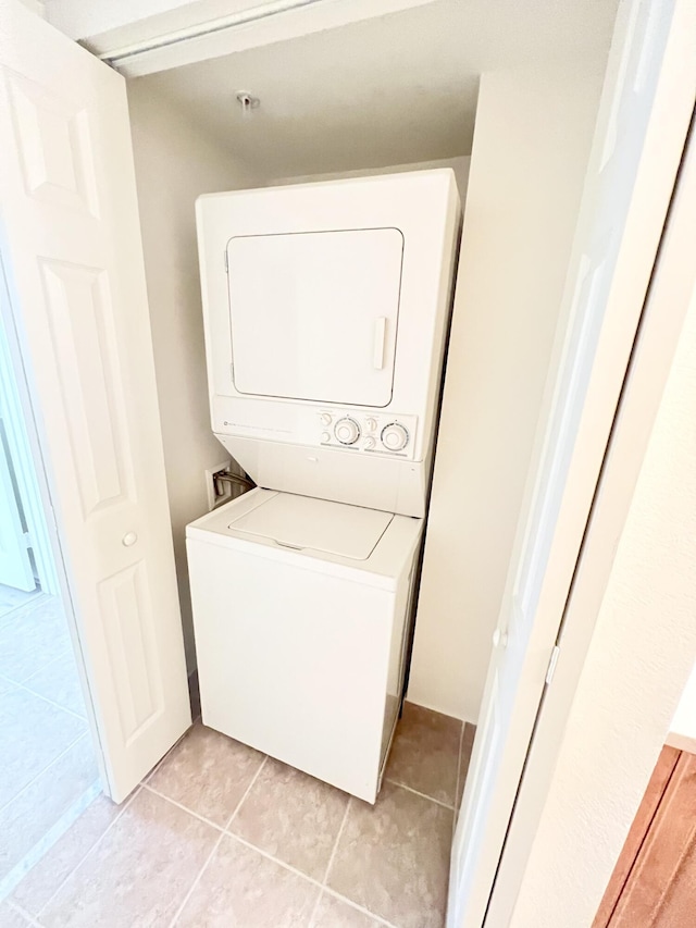 6761 Heritage Grande Unit 3303, Boynton Beach, FL 33437 - laundry area with stacked washer / drying machine and light tile patterned floors