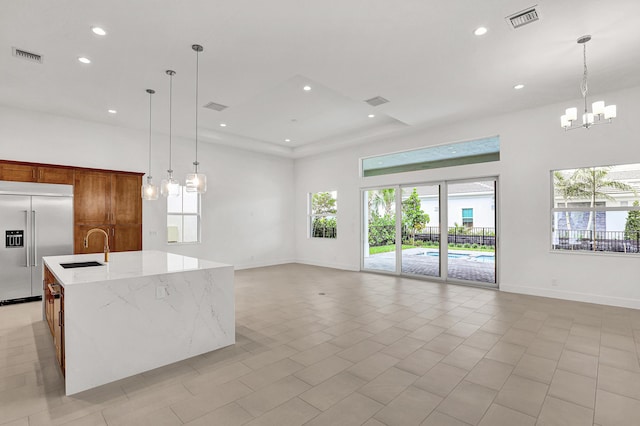 10051 Timber Creek Way, Palm Beach Gardens, FL 33412 - kitchen featuring built in fridge, a chandelier, open floor plan, a kitchen island with sink, and recessed lighting