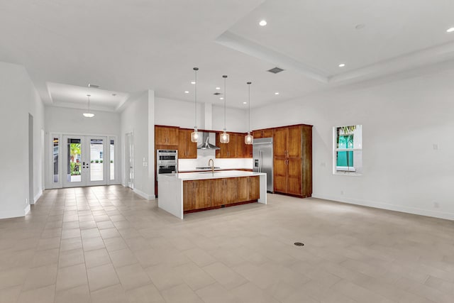 10051 Timber Creek Way, Palm Beach Gardens, FL 33412 - kitchen with wall chimney range hood, open floor plan, stainless steel appliances, a towering ceiling, and recessed lighting