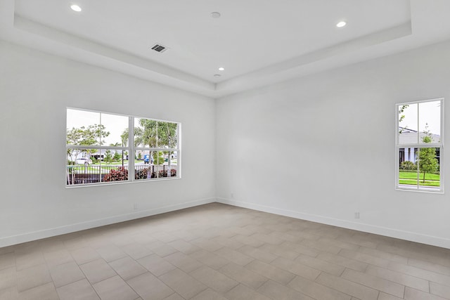 10051 Timber Creek Way, Palm Beach Gardens, FL 33412 - spare room featuring a tray ceiling, plenty of natural light, and recessed lighting