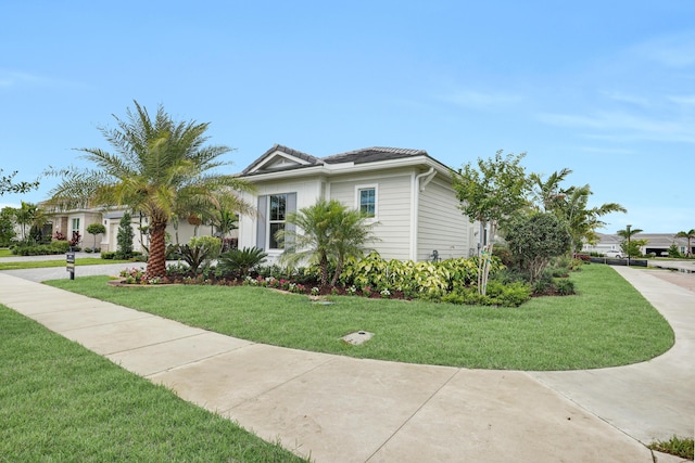 10051 Timber Creek Way, Palm Beach Gardens, FL 33412 - view of front of house featuring a front yard and a tiled roof