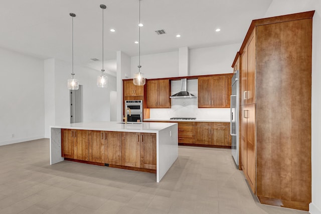 10051 Timber Creek Way, Palm Beach Gardens, FL 33412 - kitchen featuring wall chimney range hood, brown cabinets, appliances with stainless steel finishes, a large island, and light countertops