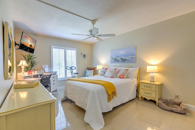 4452 NE Ocean Blvd Unit C2, Jensen Beach, FL 34957 - bedroom with a ceiling fan, light tile patterned flooring, and a textured ceiling