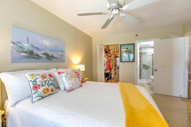 4452 NE Ocean Blvd Unit C2, Jensen Beach, FL 34957 - bedroom with tile patterned floors, a closet, ensuite bathroom, a ceiling fan, and a walk in closet