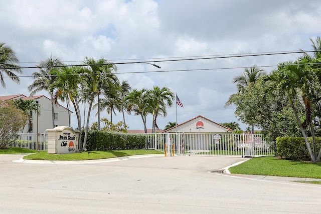 4452 NE Ocean Blvd Unit C2, Jensen Beach, FL 34957 - view of asphalt street with a gated entry, curbs, and a gate