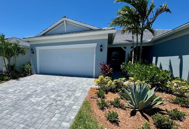 1236 Harper Way Unit 57, Vero Beach, FL 32960 - single story home with a garage, decorative driveway, stucco siding, and a tile roof
