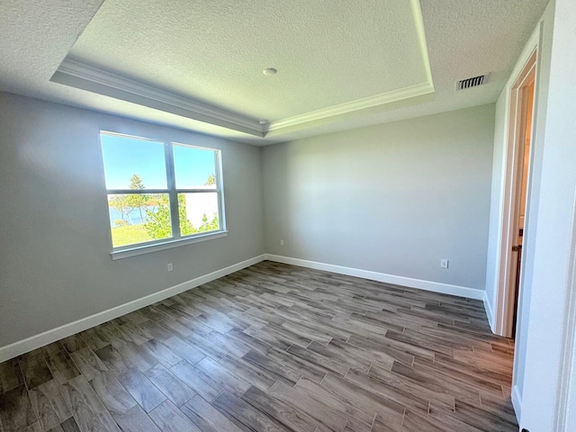 1236 Harper Way Unit 57, Vero Beach, FL 32960 - empty room with a raised ceiling, a textured ceiling, and wood finished floors