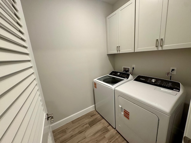 1236 Harper Way Unit 57, Vero Beach, FL 32960 - washroom featuring cabinet space, washing machine and dryer, and light wood finished floors