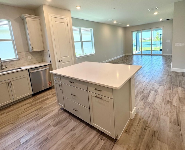 1236 Harper Way Unit 57, Vero Beach, FL 32960 - kitchen with dishwasher, light countertops, light wood finished floors, tasteful backsplash, and recessed lighting
