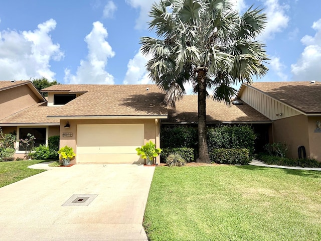 11898 Donlin Dr, Wellington, FL 33414 - view of front of home featuring an attached garage, driveway, a front lawn, stucco siding, and roof with shingles