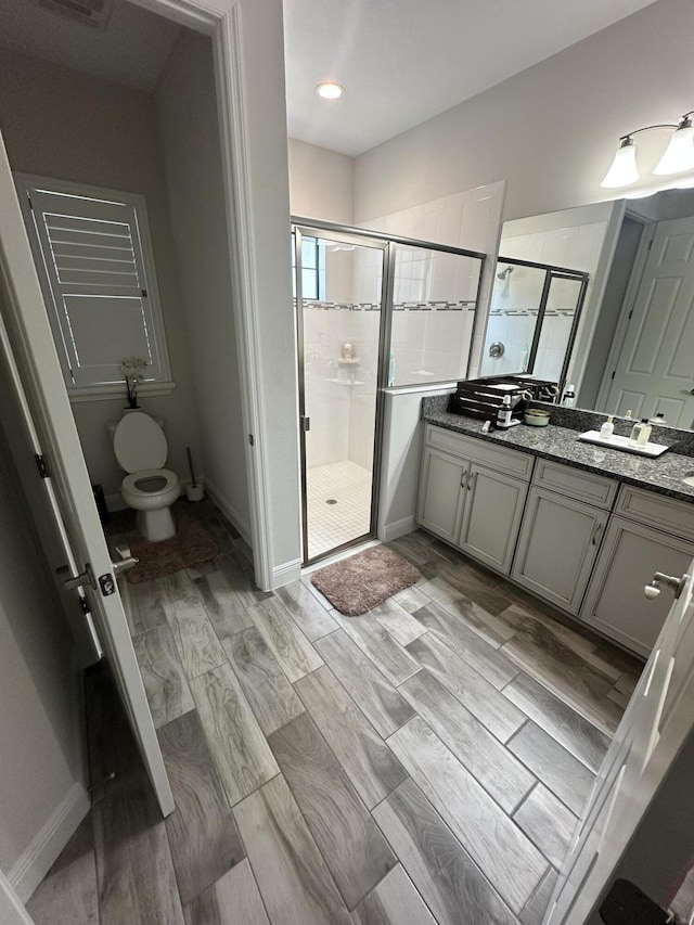 13106 Jeter Creek Dr, Riverview, FL 33579 - bathroom featuring a stall shower, vanity, wood finished floors, and recessed lighting