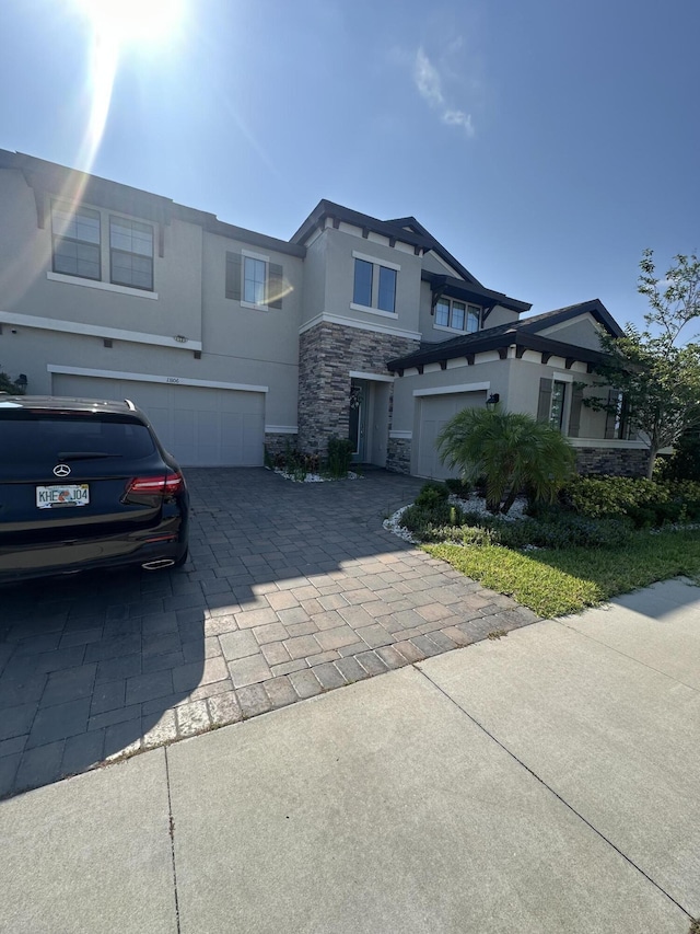 13106 Jeter Creek Dr, Riverview, FL 33579 - view of front of property with stone siding, a garage, decorative driveway, and stucco siding