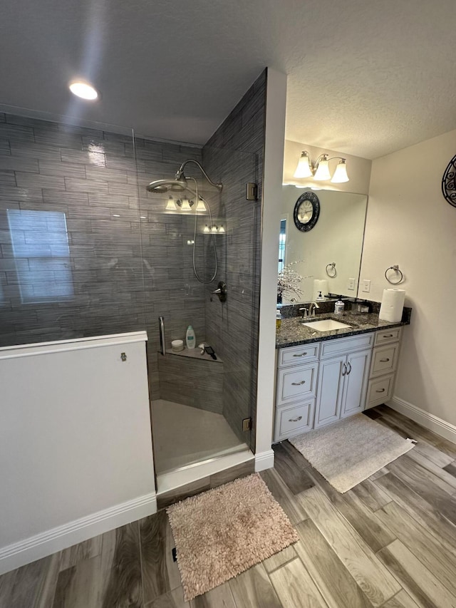 13106 Jeter Creek Dr, Riverview, FL 33579 - bathroom with vanity, a tile shower, and wood finished floors