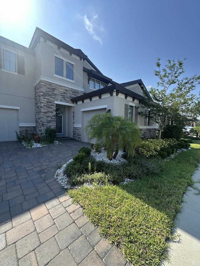 13106 Jeter Creek Dr, Riverview, FL 33579 - view of property exterior featuring stone siding, stucco siding, and driveway