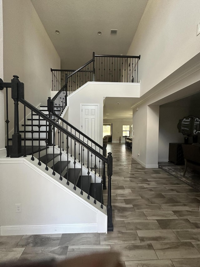 13106 Jeter Creek Dr, Riverview, FL 33579 - staircase with a towering ceiling and wood finished floors