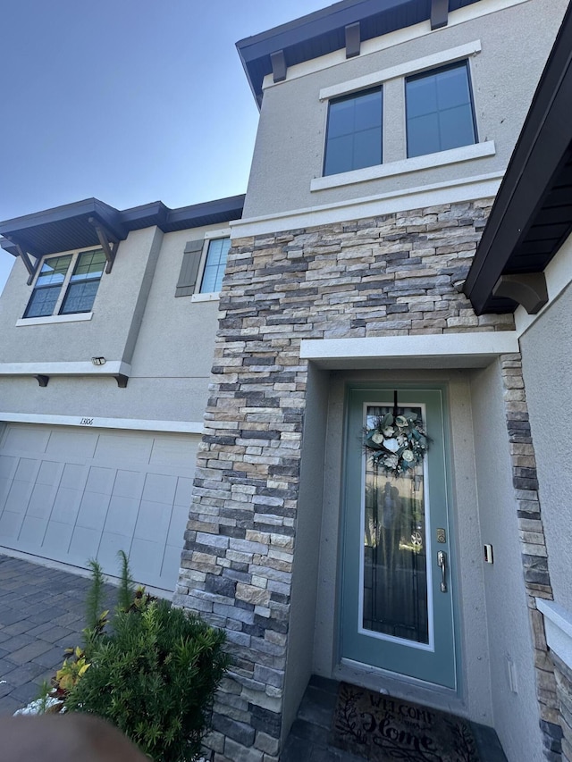13106 Jeter Creek Dr, Riverview, FL 33579 - property entrance featuring stucco siding, a garage, and stone siding