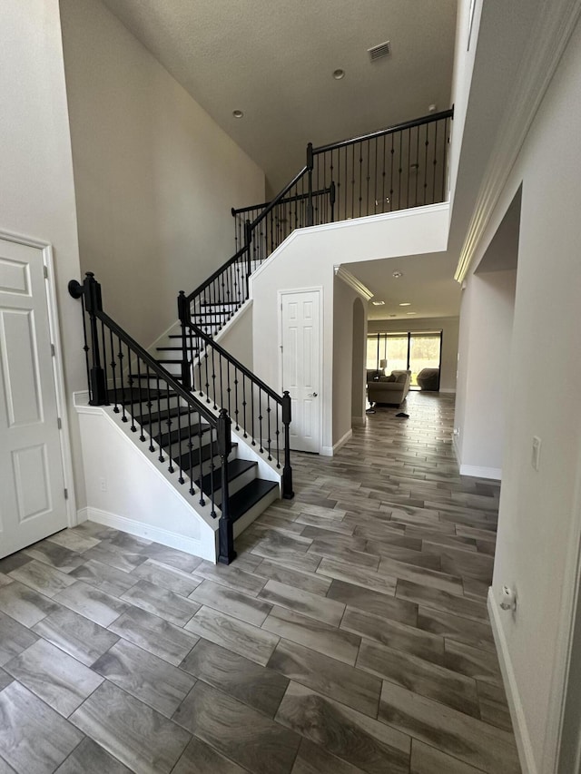 13106 Jeter Creek Dr, Riverview, FL 33579 - entrance foyer with arched walkways, a towering ceiling, and stairway