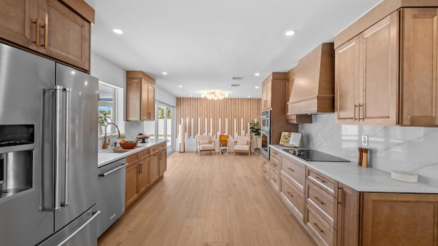 2654 NW 32nd St, Boca Raton, FL 33434 - kitchen with appliances with stainless steel finishes, custom exhaust hood, light wood finished floors, recessed lighting, and backsplash