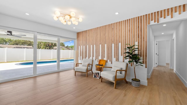 2654 NW 32nd St, Boca Raton, FL 33434 - living area featuring light wood-style floors, recessed lighting, ceiling fan, and a chandelier