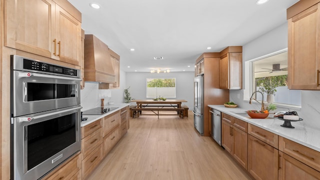 2654 NW 32nd St, Boca Raton, FL 33434 - kitchen featuring appliances with stainless steel finishes, light wood-style flooring, light countertops, recessed lighting, and custom exhaust hood