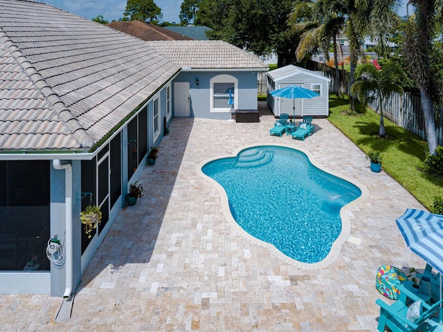1101 SW Kickaboo Rd, Port Saint Lucie, FL 34953 - view of swimming pool with a fenced backyard, a patio area, a storage shed, and a sunroom