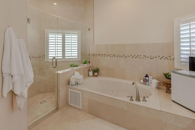 1101 SW Kickaboo Rd, Port Saint Lucie, FL 34953 - full bathroom with a tub with jets, plenty of natural light, a stall shower, and tile walls