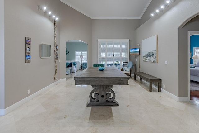 1101 SW Kickaboo Rd, Port Saint Lucie, FL 34953 - dining space featuring arched walkways, crown molding, a high ceiling, and marble finish floors