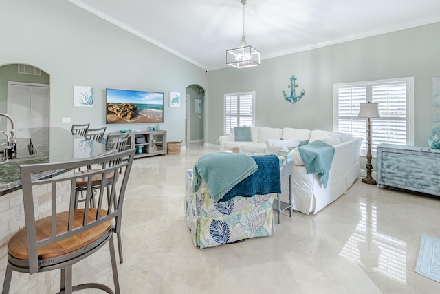 1101 SW Kickaboo Rd, Port Saint Lucie, FL 34953 - living room with arched walkways, a chandelier, crown molding, and lofted ceiling