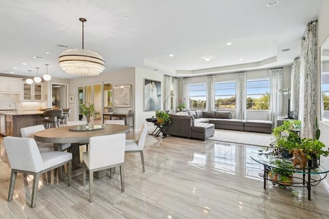 242 Tresana Blvd Unit 70, Jupiter, FL 33478 - dining room featuring a tray ceiling, recessed lighting, and a chandelier