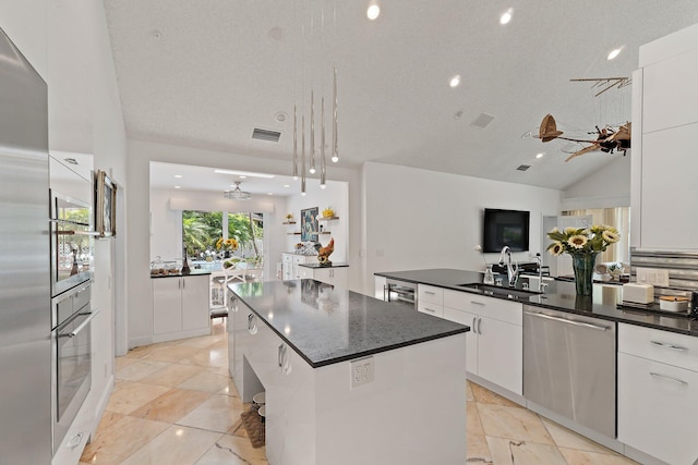 13709 Rivoli Dr, Palm Beach Gardens, FL 33410 - kitchen featuring appliances with stainless steel finishes, white cabinetry, modern cabinets, a kitchen island, and decorative light fixtures