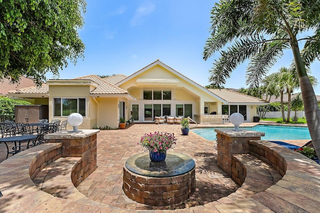 13709 Rivoli Dr, Palm Beach Gardens, FL 33410 - back of house with a tiled roof, a patio area, and stucco siding