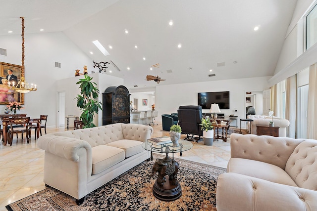 13709 Rivoli Dr, Palm Beach Gardens, FL 33410 - living area with high vaulted ceiling, recessed lighting, a chandelier, and a skylight