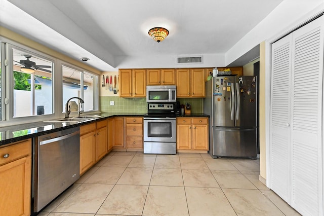 3560 SW 63rd Ave, Miramar, FL 33023 - kitchen with appliances with stainless steel finishes, tasteful backsplash, dark countertops, and light tile patterned flooring
