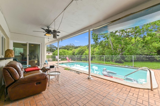 3560 SW 63rd Ave, Miramar, FL 33023 - view of swimming pool with a fenced backyard, a ceiling fan, a patio, and view of wooded area