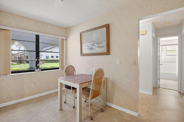 8811 SW 21st Ct Unit B, Boca Raton, FL 33433 - dining space featuring healthy amount of natural light, a textured ceiling, wallpapered walls, and tile patterned floors