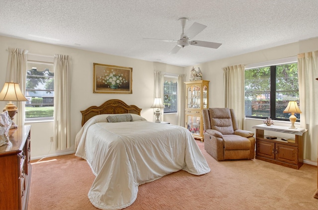 8811 SW 21st Ct Unit B, Boca Raton, FL 33433 - bedroom with light colored carpet, a textured ceiling, and ceiling fan