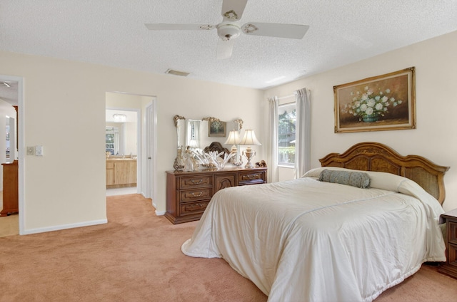 8811 SW 21st Ct Unit B, Boca Raton, FL 33433 - bedroom featuring light colored carpet, a textured ceiling, connected bathroom, and ceiling fan