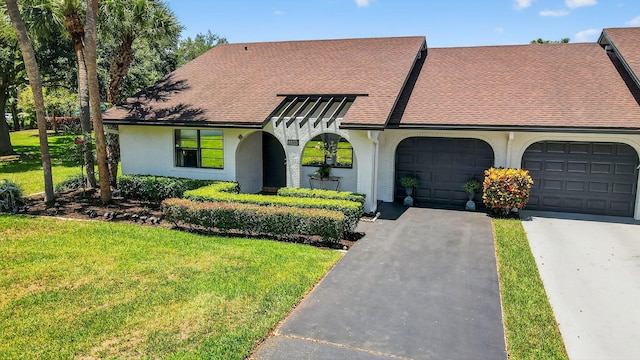8811 SW 21st Ct Unit B, Boca Raton, FL 33433 - view of front facade featuring a garage, driveway, a shingled roof, stucco siding, and a front yard