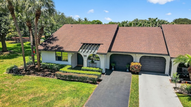 8811 SW 21st Ct Unit B, Boca Raton, FL 33433 - view of front of property featuring a garage, asphalt driveway, a front lawn, stucco siding, and a shingled roof
