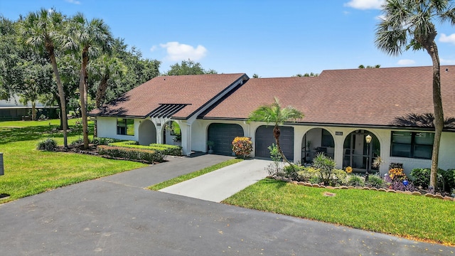8811 SW 21st Ct Unit B, Boca Raton, FL 33433 - view of front of house featuring an attached garage, a front lawn, driveway, stucco siding, and roof with shingles
