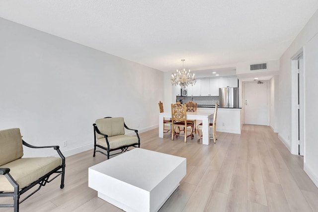 3540 S Ocean Blvd Ph 911, South Palm Beach, FL 33480 - living room featuring a chandelier, light wood finished floors, and recessed lighting