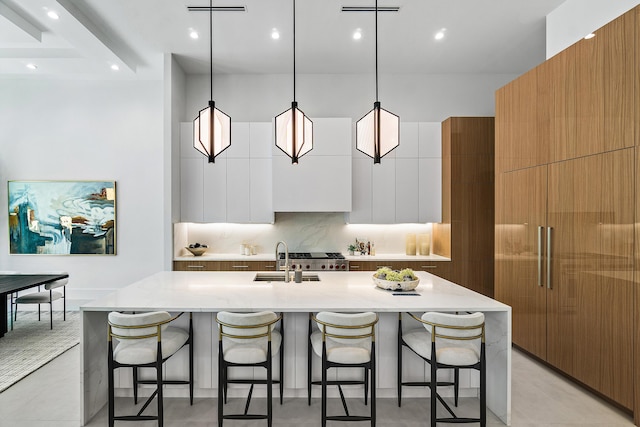 17 NW 15th St, Delray Beach, FL 33444 - kitchen with modern cabinets, a kitchen bar, decorative backsplash, and recessed lighting