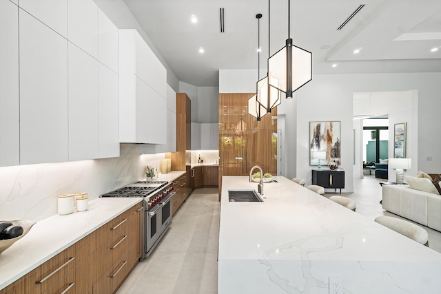 17 NW 15th St, Delray Beach, FL 33444 - kitchen featuring double oven range, modern cabinets, open floor plan, decorative backsplash, and a large island