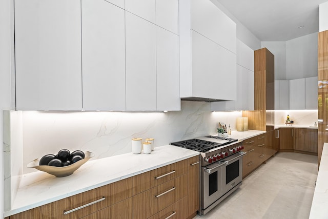 17 NW 15th St, Delray Beach, FL 33444 - kitchen featuring range with two ovens, modern cabinets, white cabinets, decorative backsplash, and light stone counters