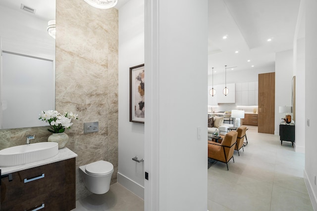 17 NW 15th St, Delray Beach, FL 33444 - bathroom featuring tile walls, vanity, tile patterned flooring, and recessed lighting