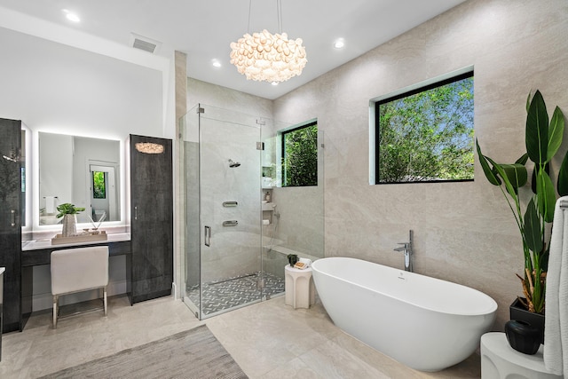 17 NW 15th St, Delray Beach, FL 33444 - full bathroom featuring a shower stall, a soaking tub, tile walls, a chandelier, and recessed lighting
