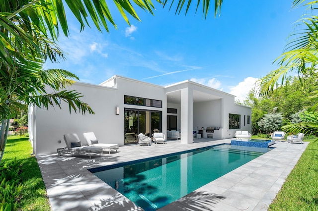 17 NW 15th St, Delray Beach, FL 33444 - view of swimming pool featuring outdoor lounge area, a patio area, a pool with connected hot tub, and grilling area