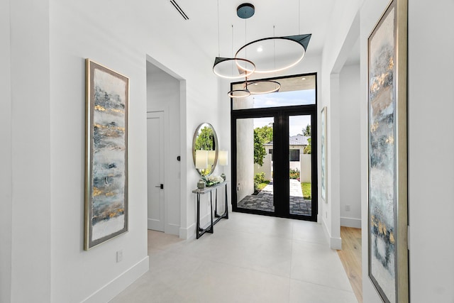 17 NW 15th St, Delray Beach, FL 33444 - foyer with light tile patterned floors, a high ceiling, and french doors