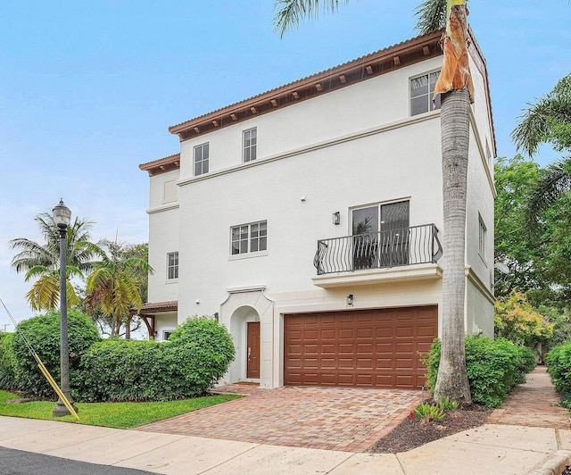 674 NW Library Commons Way, Boca Raton, FL 33432 - mediterranean / spanish-style house with a balcony, an attached garage, stucco siding, and decorative driveway