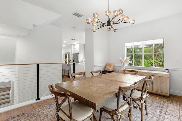 674 NW Library Commons Way, Boca Raton, FL 33432 - dining room featuring light wood-type flooring and a chandelier